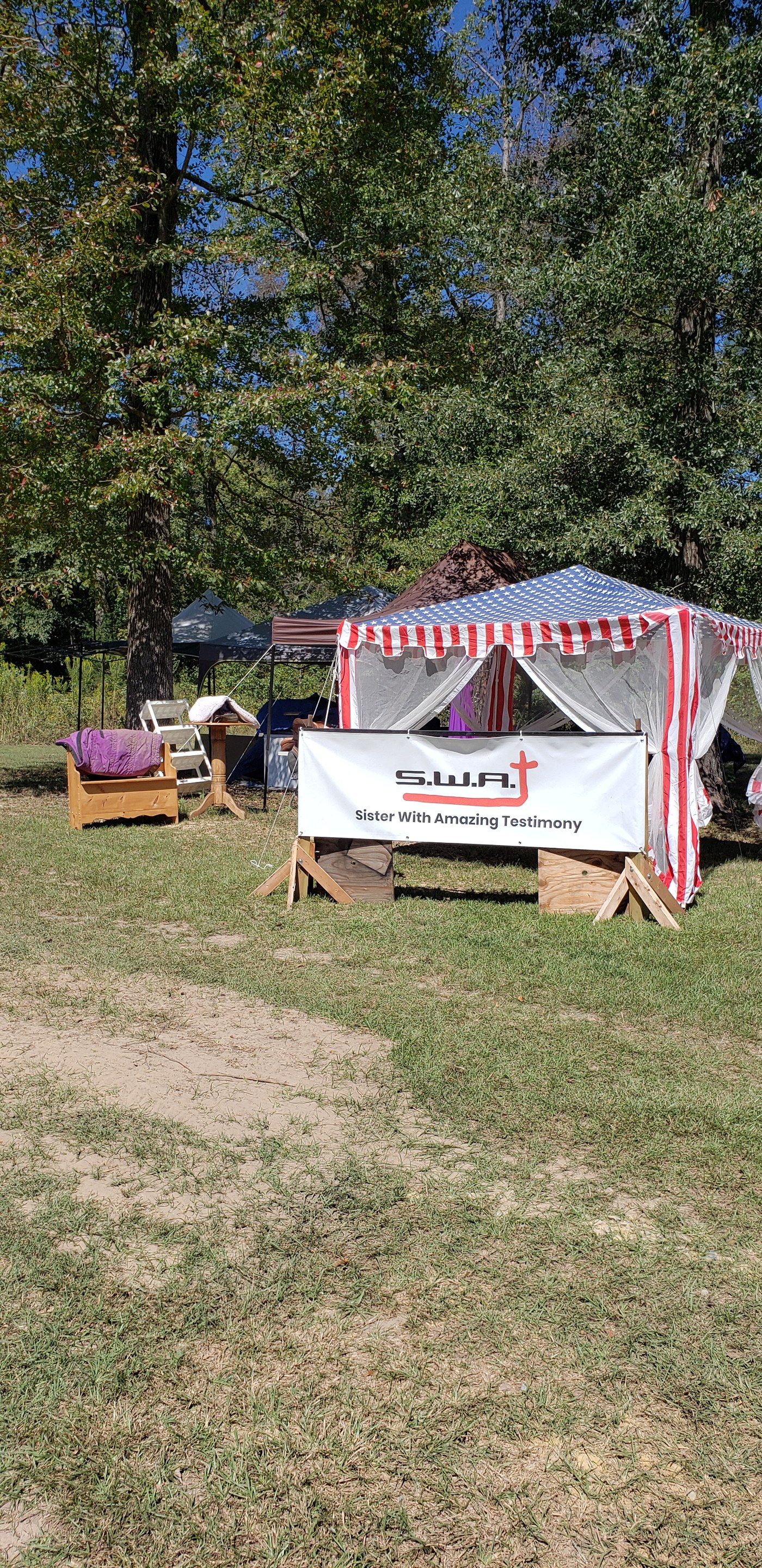 S.W.A.T. tent banner — Sister With Amazing Testimony — at outreach